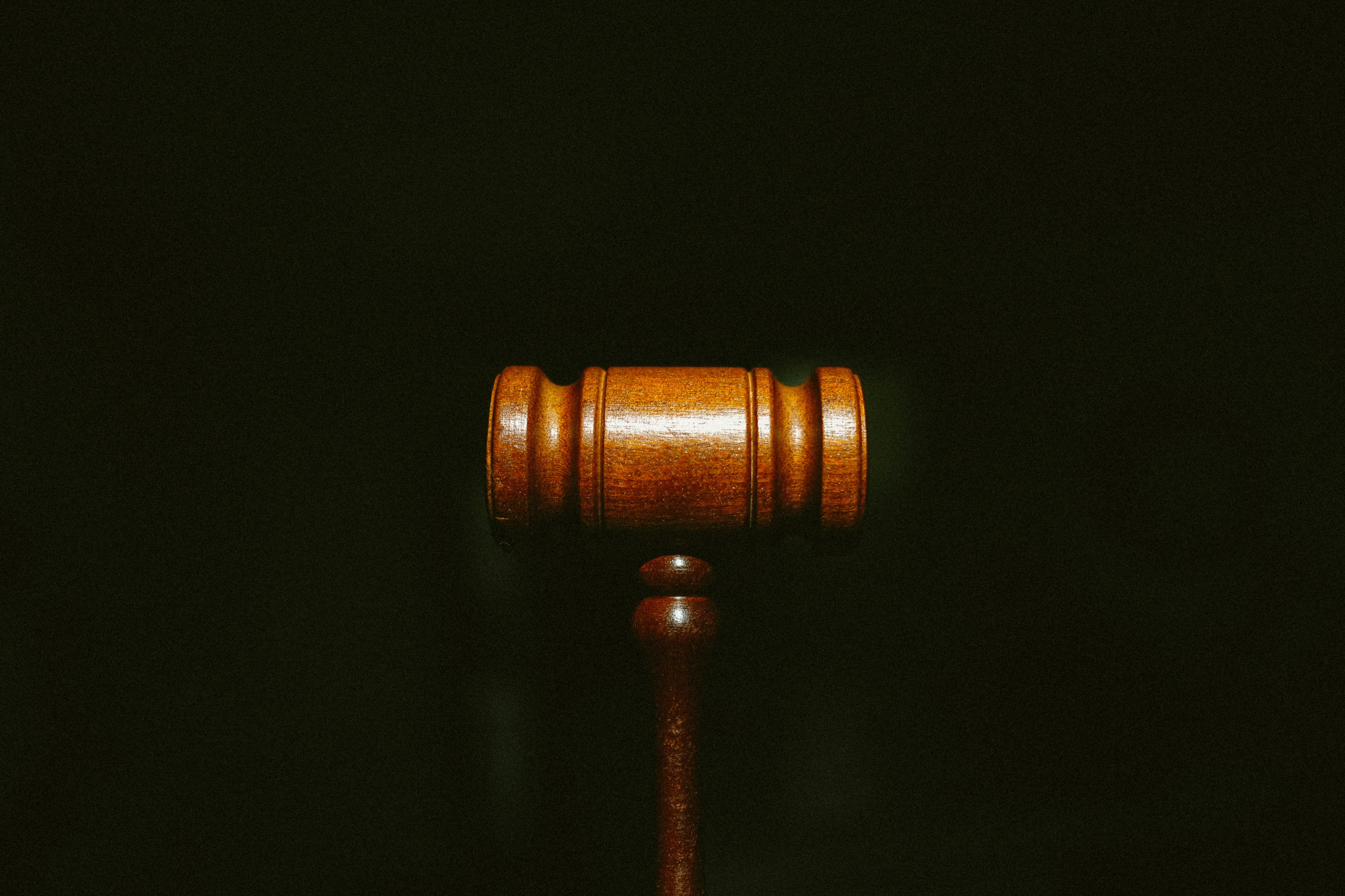 Wooden judge's gavel on a dark background