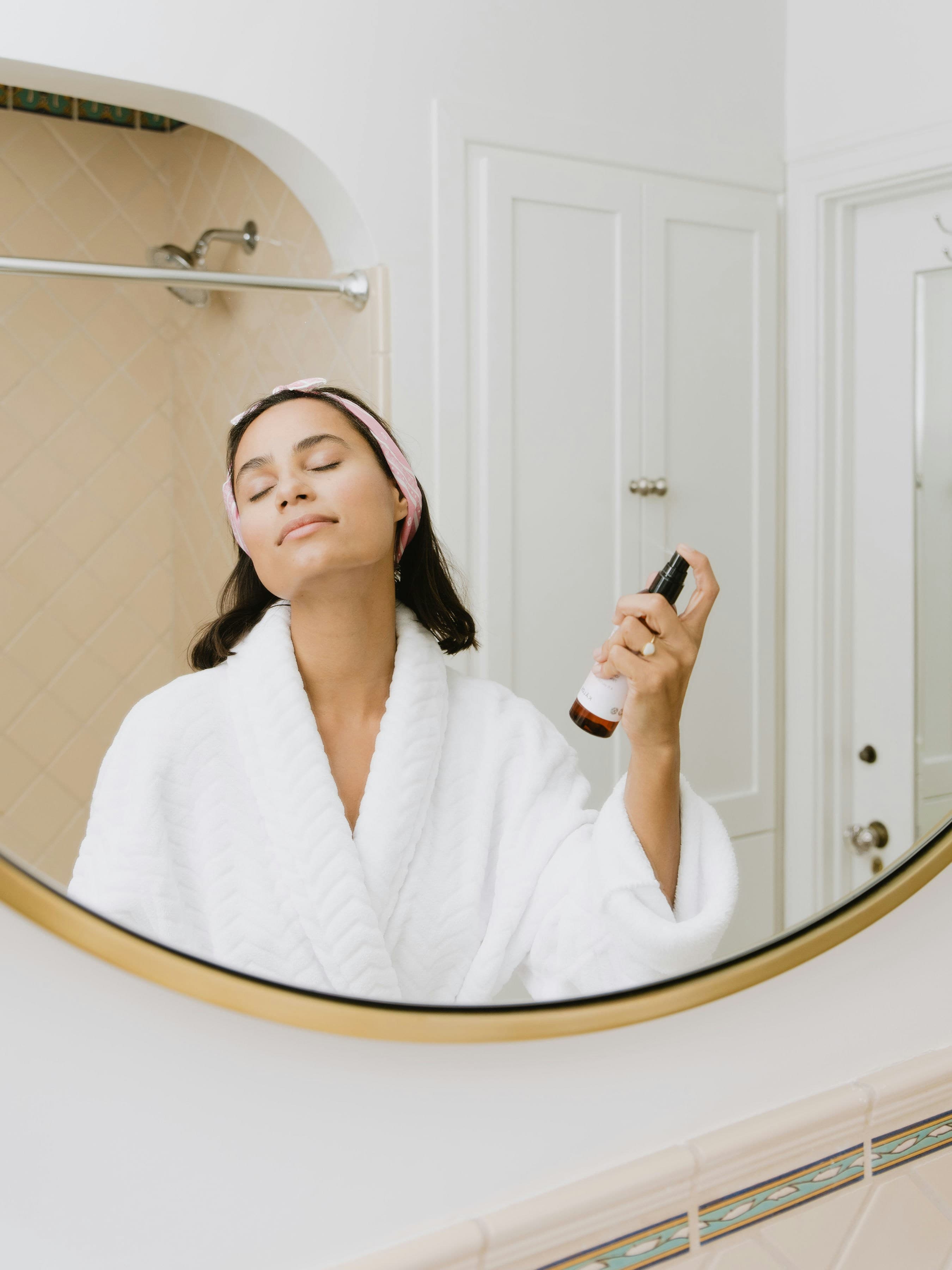Woman spraying facial mist