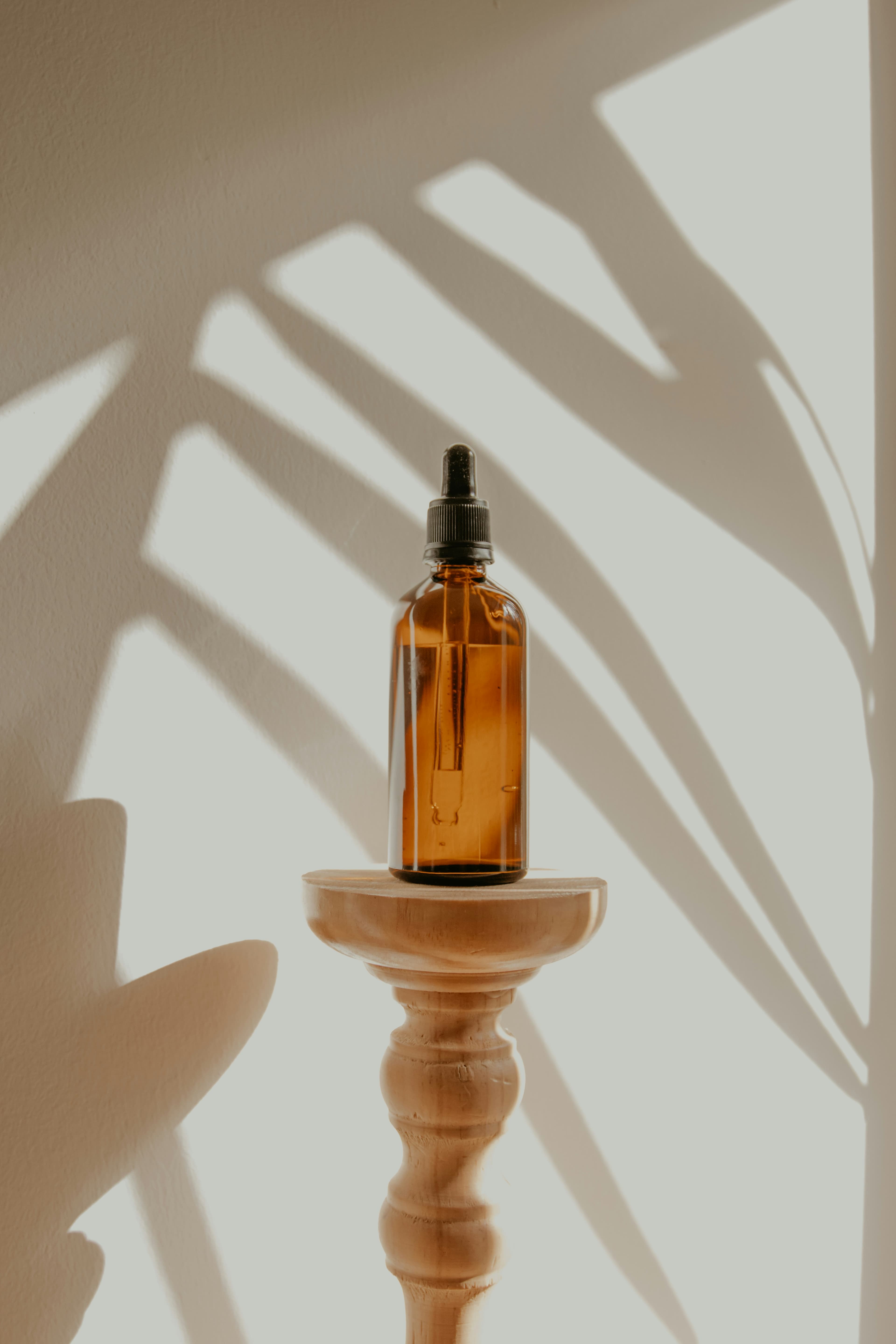 Amber dropper bottle on a pedestal