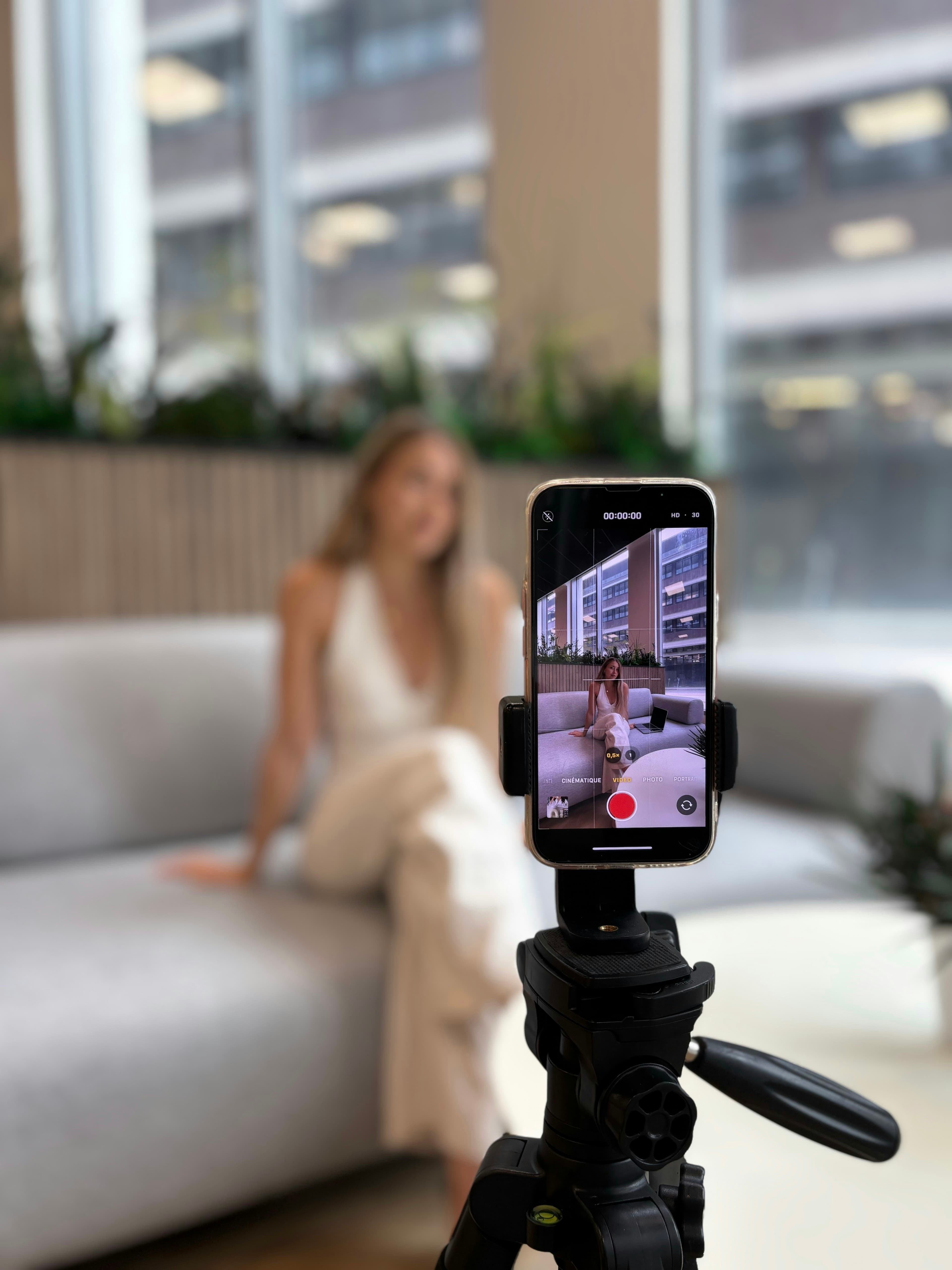Creator recording herself on a smartphone tripod
